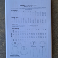Sewing pattern book with size chart and fabric consumption details on a textured surface