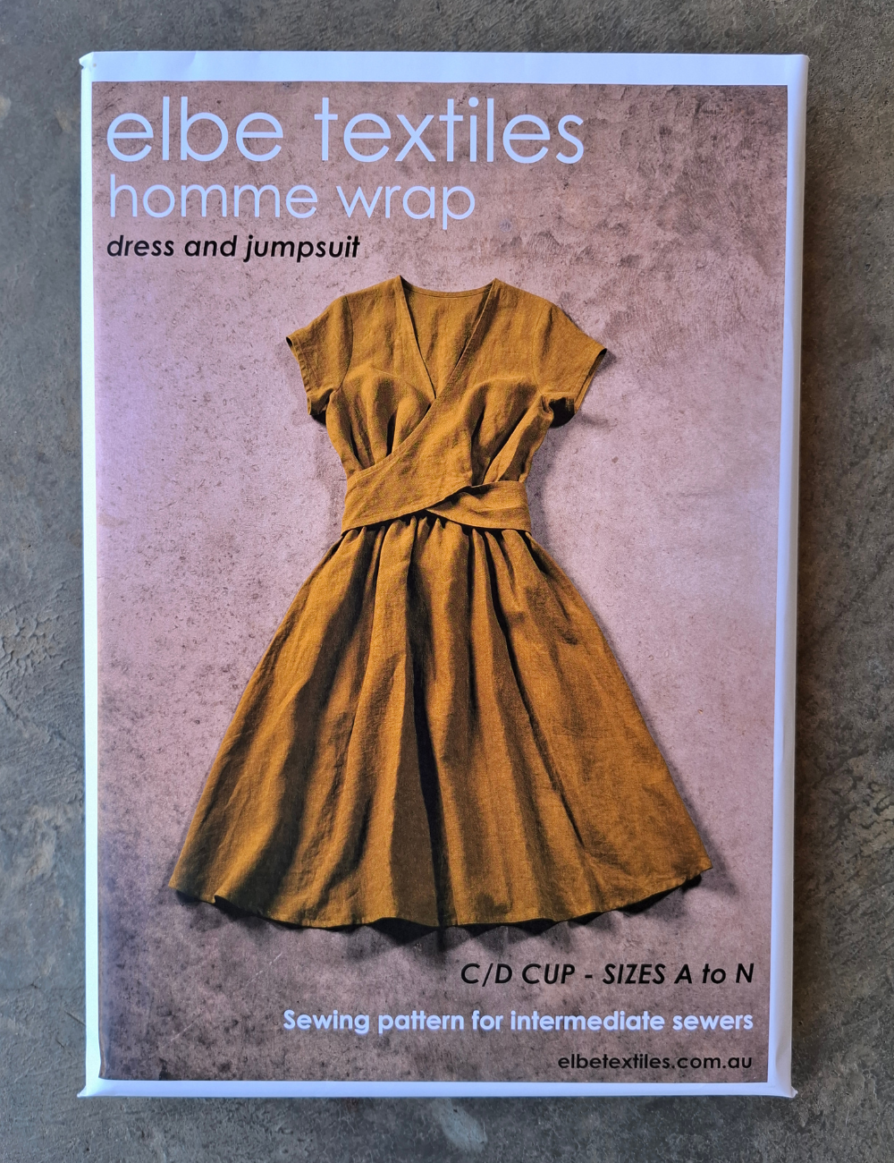 Elbe Textiles homme wrap dress and jumpsuit sewing pattern packaging on a textured surface